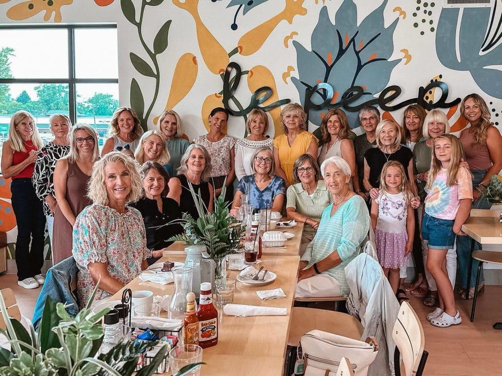 A large group seated together at a long table at Le Peep in Valparaiso